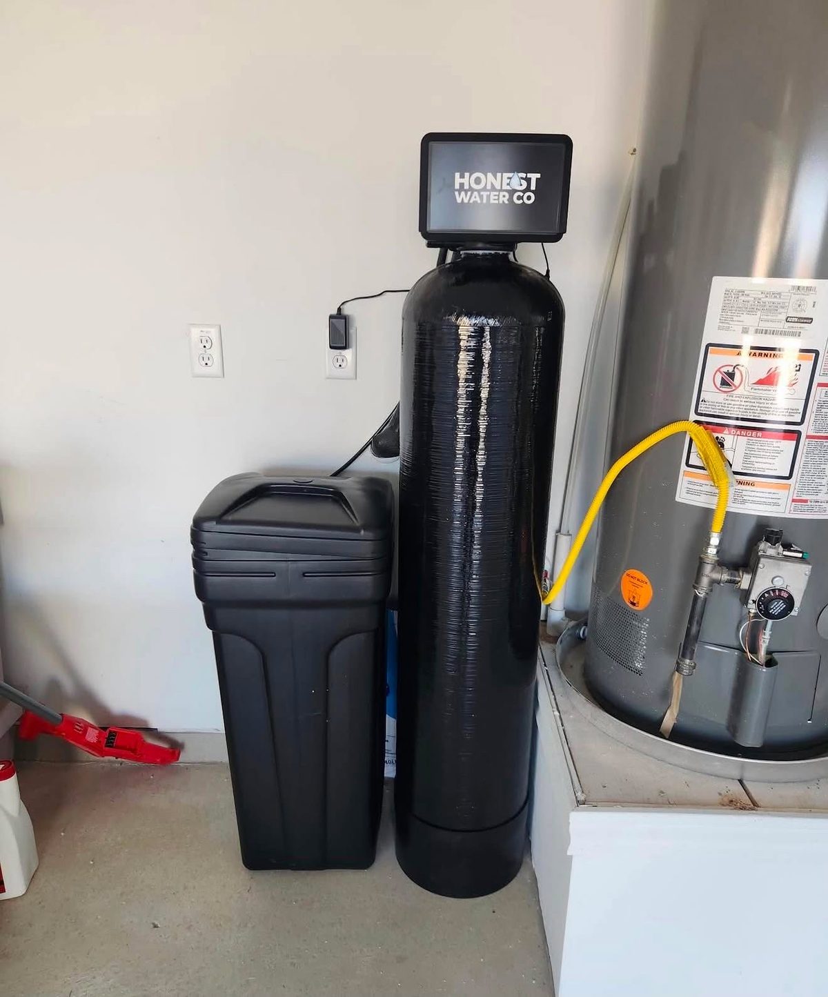 Whole home water treatment system with custom-fitted cover installed in a Clovis CA garage